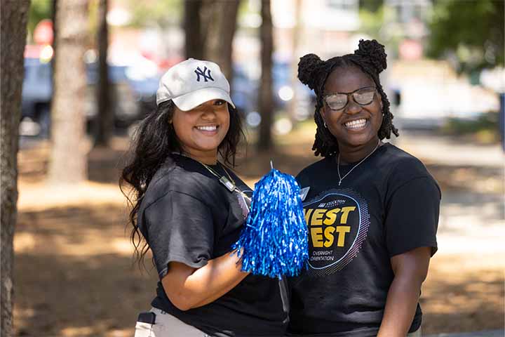 two female students with pom-poms