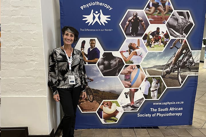 Mary Lou Galantino in front of a physiotherapy banner