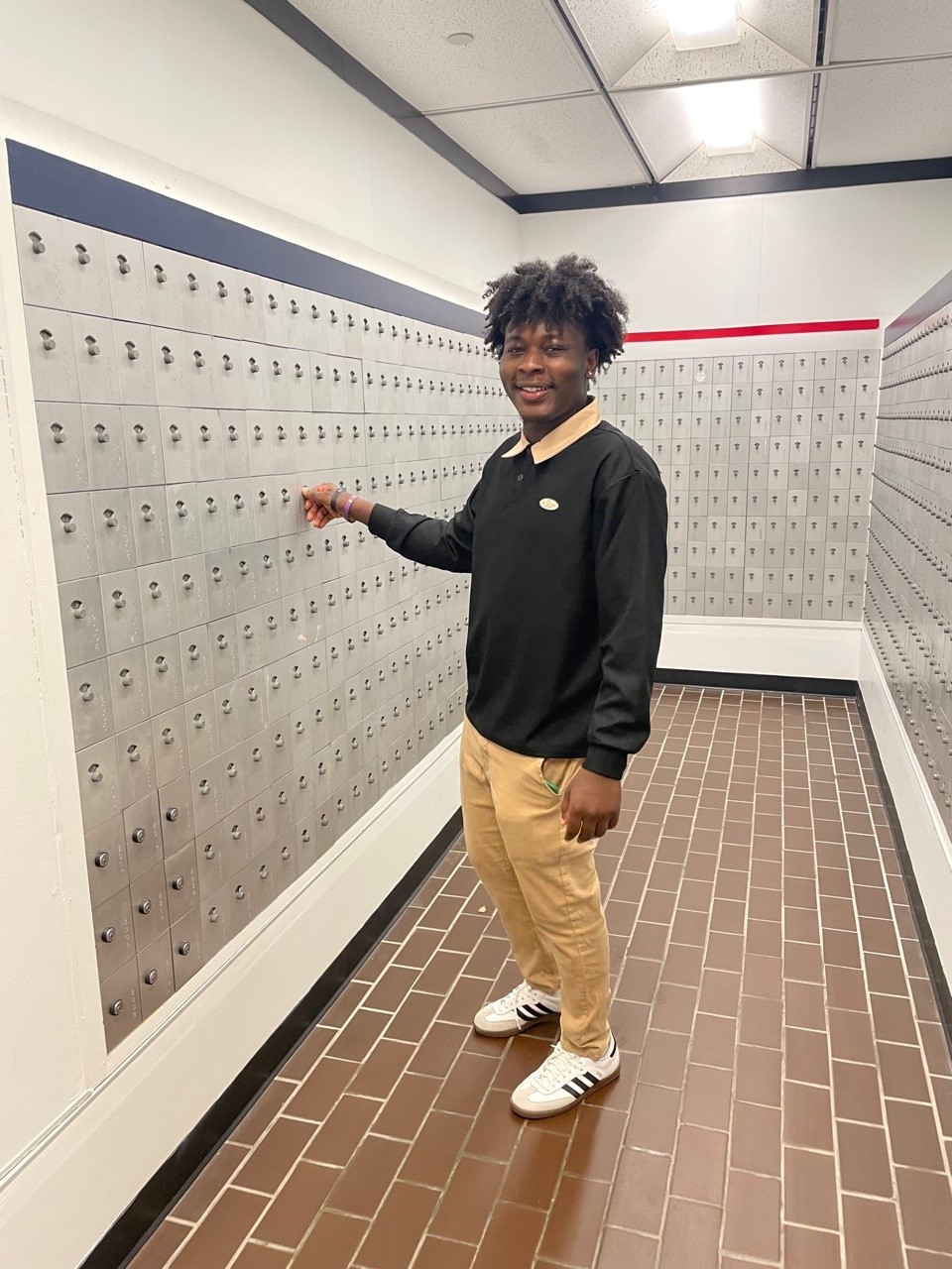 Student Worker is posed near the student mailboxes Student Worker is posed near the student mailboxes