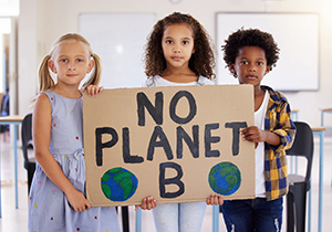 Kids holding up No Planet B sign