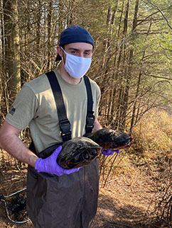 Image of student with turtles