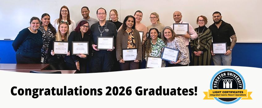 Integrated Casino Resort Operations Certificate - Cohort Three Group of program graduates instructors and administrators smile at the camera. Graduates hold their framed certificates.