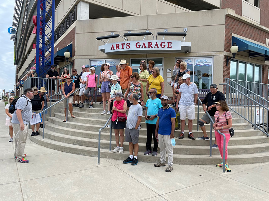 Participants stop on steps of Noyes Arts Garage&nbsp;of Stockton University to listen to tour guide Levi Fox.&nbsp;