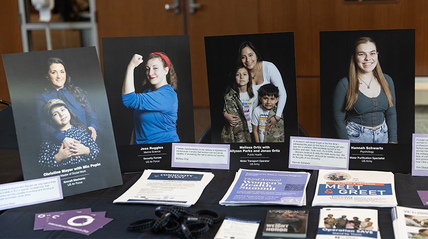 Portraits of female veterans on display for the Office for Military and Veterans' table.