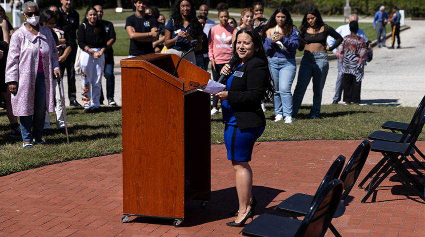 Jovin Fernandez standing at a podium in front of crowd 