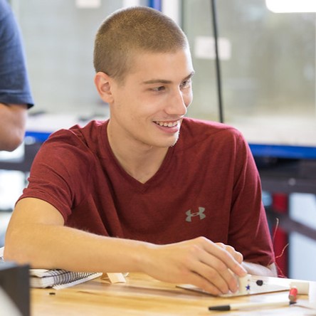 Student smiling and talking at registration