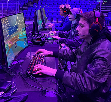 three male students playing esports