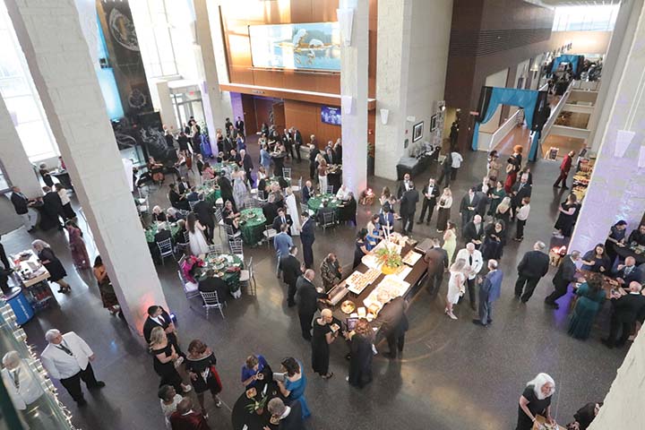 An aerial view of guests mingling in the Campus Center Grand Hall during the Scholarship Benefit Gala