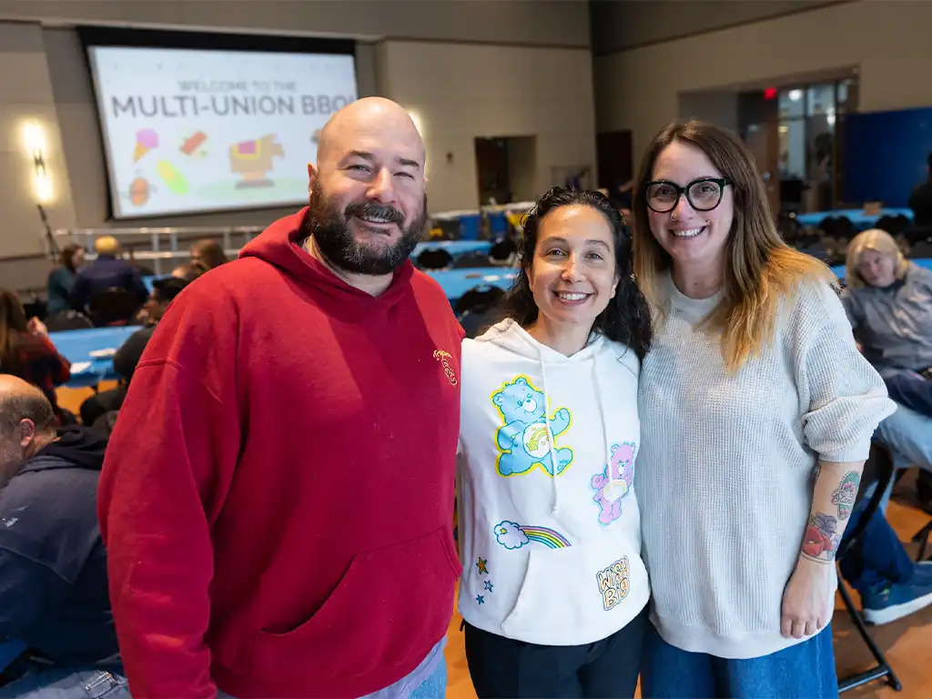 Three people smiling and posing together at Stockton University’s Multi-Union BBQ event.